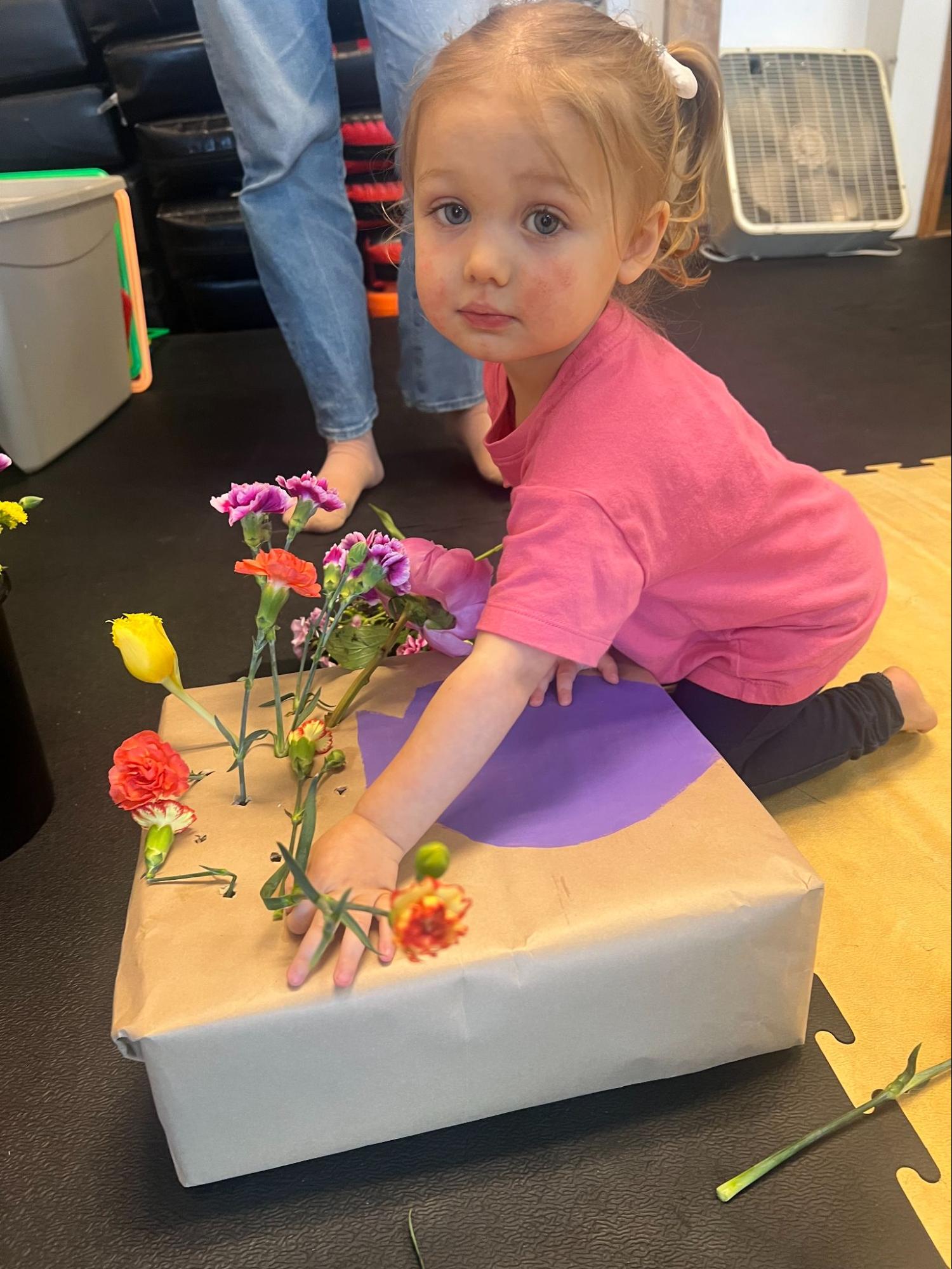 Child arranging flowers in sensory activity