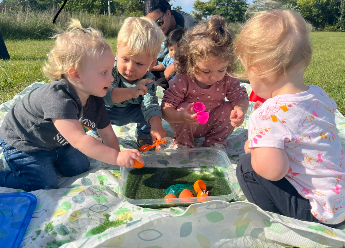 Children engaged in sensory play circle